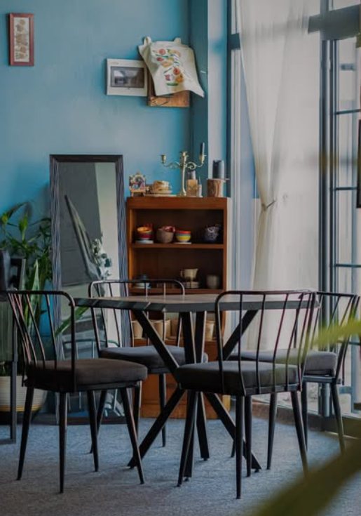 A quiet corner with a dining table, vintage shelf and candlesticks